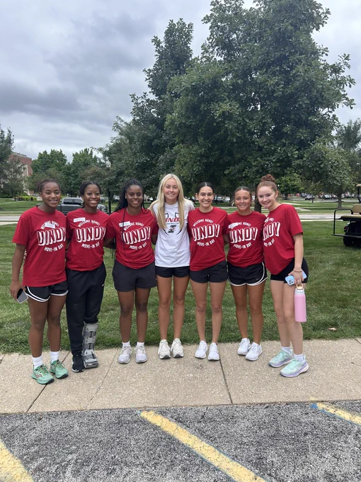 Freshman Taylor poses with her teammates from UIndy women’s basketball outside her new dorm during move-in day.