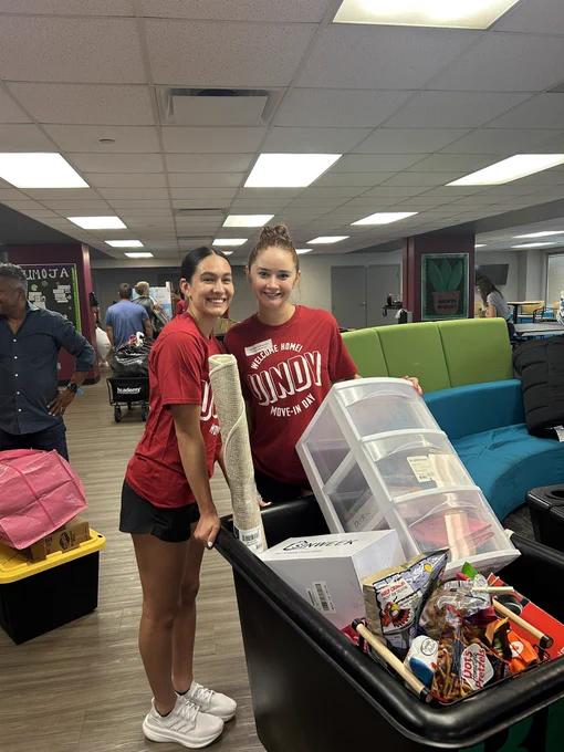 University of Indianapolis women’s basketball players smiling and posing together during campus move-in day