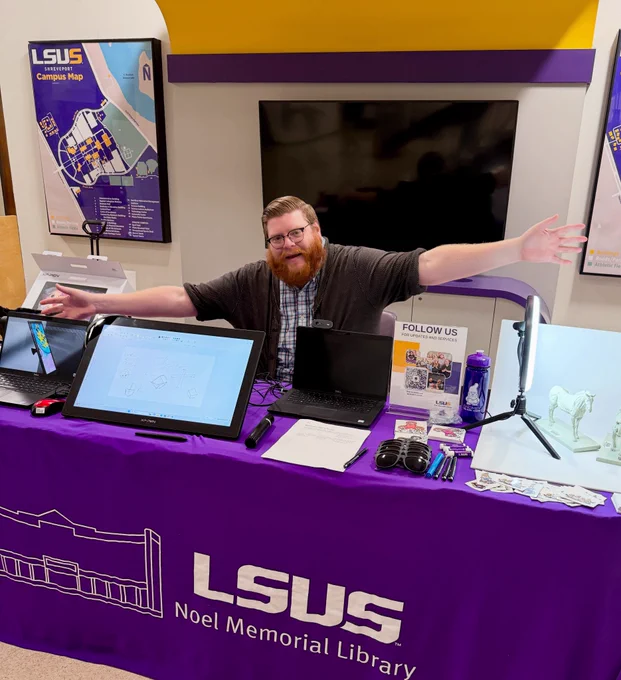 LSUS Noel Memorial Library Digital Strategies and Technology Librarian sitting at the Level Up Resource booth.