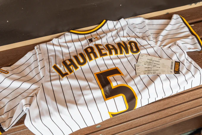Photo of a signed Ramón Laureano jersey and two tickets to a Padres game.