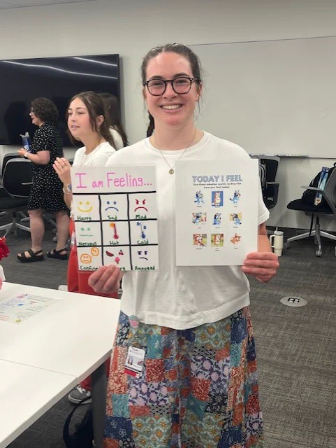 First year OT student, Kiera Hubschman, holding her OT artifact up while posing for picture