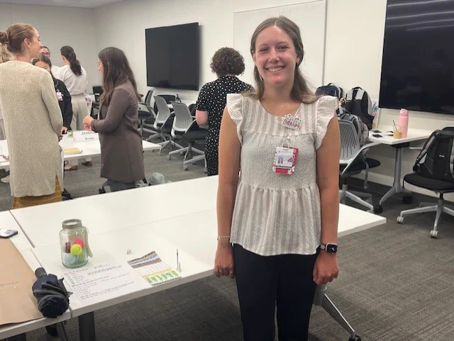First year OT student, Sarah Fryman, posing next to her OT artifact 