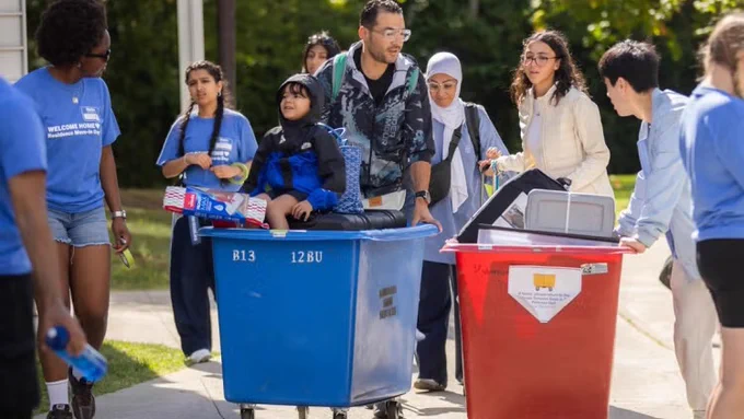 Move-in day is often a family affair. Volunteers and family members help roll students’ belongings into residence at U of T Mississauga