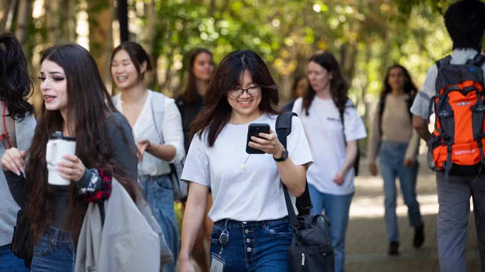 One last phone check as students make their way to class on U of T’s St. George campus on Sept. 2, the first day of the fall term