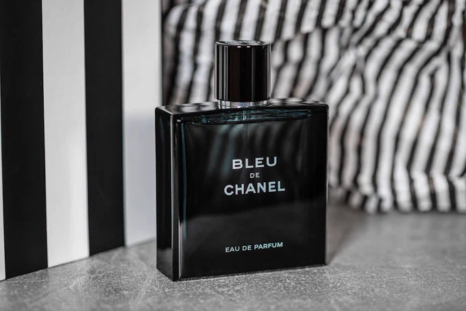 Luxurious Bleu de Chanel perfume bottle showcased with stylish backdrop for product photography.