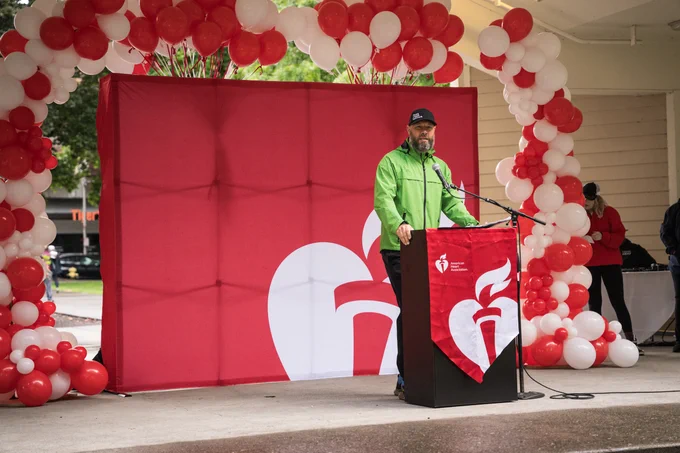 Photo of Matthew Kampfe on stage at the 2025 Vancouver Heart and Stroke Walk.