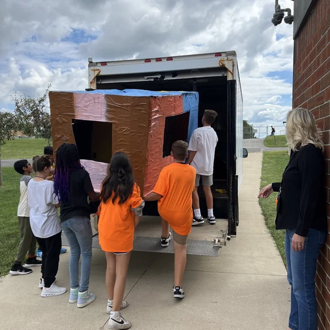 It was a team effort loading all of the cardboard boats after school today  