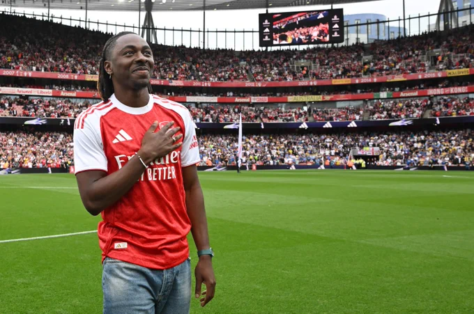 Eberechi Eze pats the badge ahead of the game at Emirates Stadium.