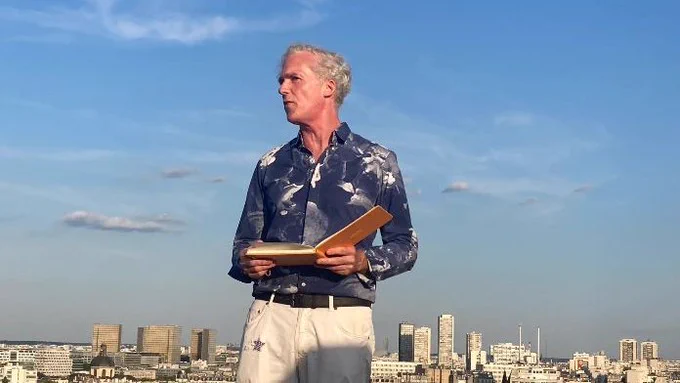 Poet Jason Stoneking reads from his Sky Sketches series on a rooftop in Paris