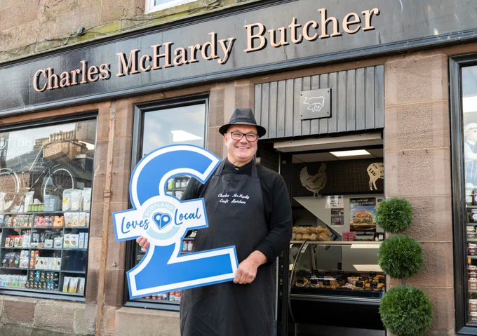 Photograph courtesy of Aberdeenshire Council Economic Development.
Robert Clark, Director, Charles McHardy Butcher, Stonehaven stands outside his family business holding a Scotland Loves Local pound sign.