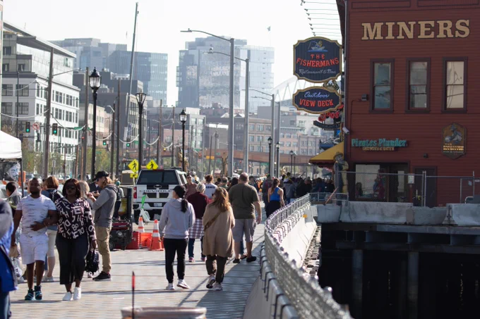 Pedestrians walk along Seattle's waterfront