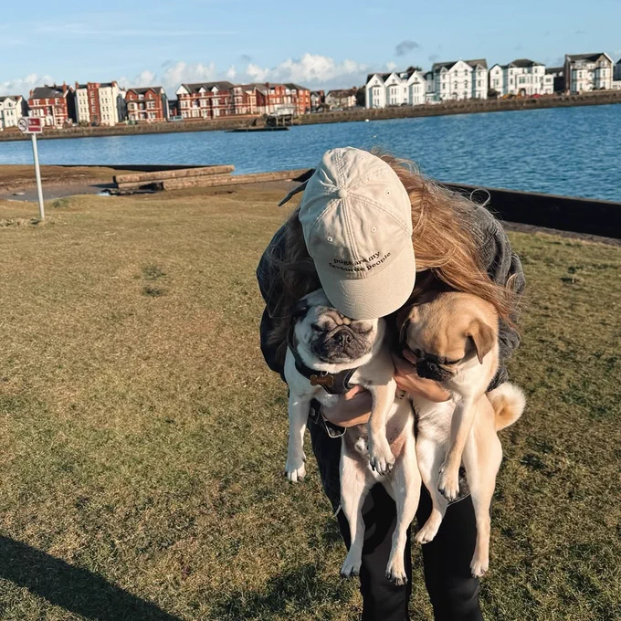 Simone Magill holds her two pugs.
