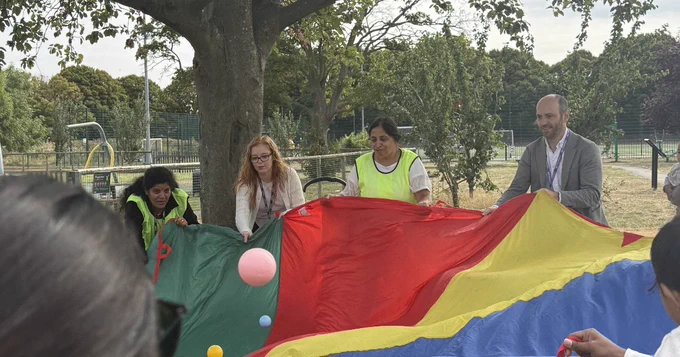 Councillor Josh Blacker joining in an Early Help play parachute activity