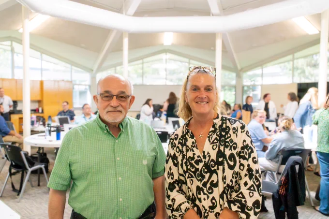 Two Marlborough School Committee members stand and smile in the Whitcomb Commons.
