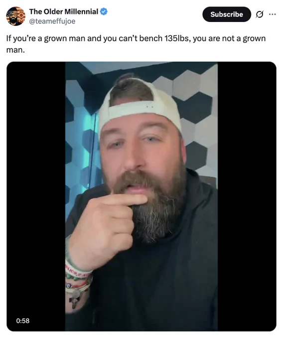 Screenshot from "The Older Millennial" (@teameffujoe). It's a still from a minute long video. "If you're a grown man and you can't bench 135lbs, you are not a grown man."