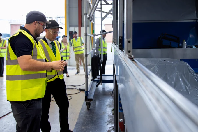 DAERA Minister Andrew Muir pictured Dr. Andy Harris, Head of Research and Data Analytics on a tour of the workshop at Wrightbus