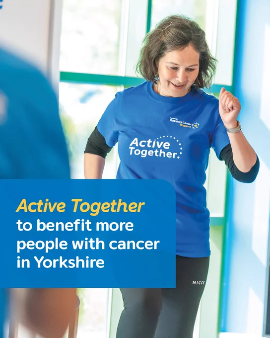 A person in a blue Active Together T-shirt smiles while taking part in an exercise session for people with cancer. The following text overlays the image "Active Together to benefit more people with cancer in Yorkshire."
