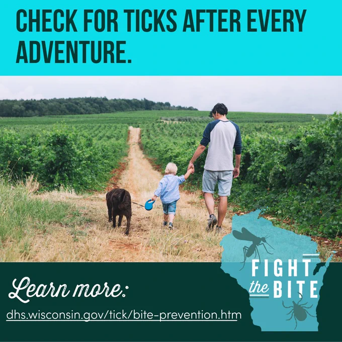 An adult walking with a child and a dog through high grass and a reminder to do a tick check after being outdoors. Fight the Bite. 