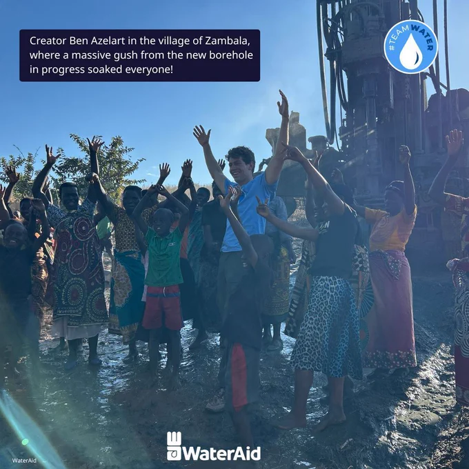 Creator Ben Azelart in the village of Zambala, where a massive gush from the new borehole in progress soaked everyone! Image credit: WaterAid