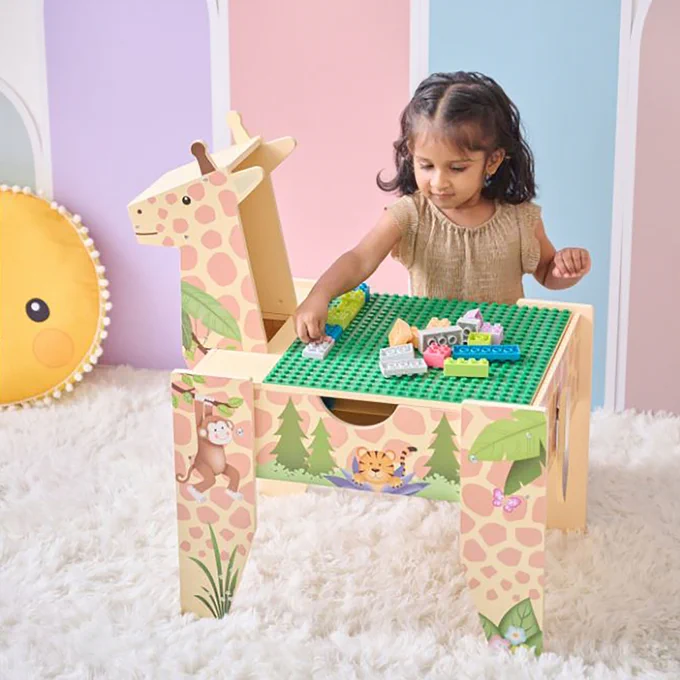 A young child plays with building blocks on a colorful, animal-themed table in a playful room setting.