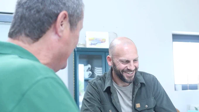 Two men sitting together at a table.