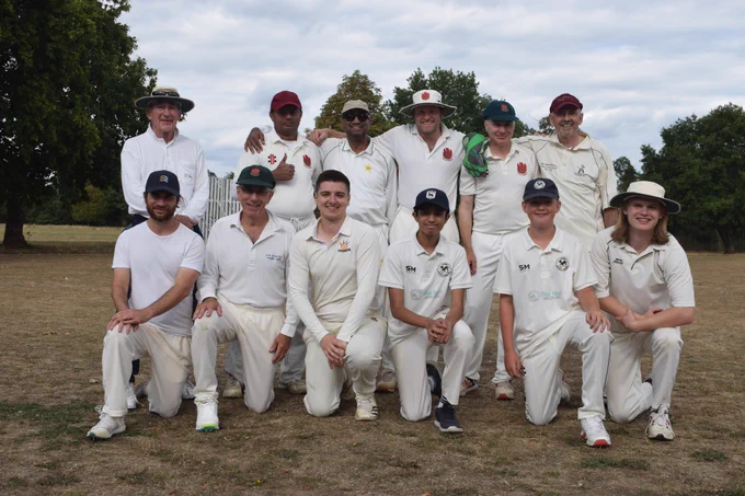Bushmen team and umpire Howard smiling in team photo