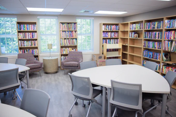 Interior space in the McLure Library. Featuring lined bookshelves and a collaborative workspace with tables and chairs.