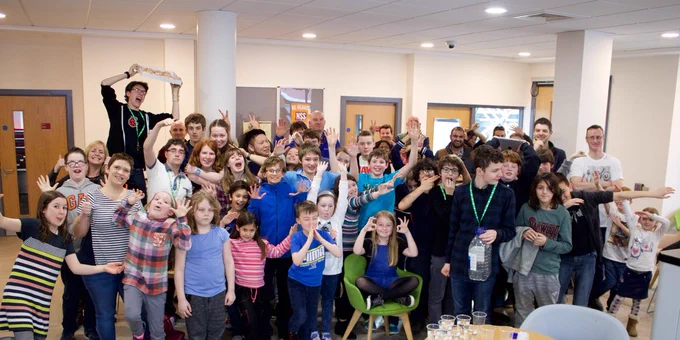 A group of young people are shown looking excited