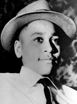 A black and white photo of Emmett Till.
