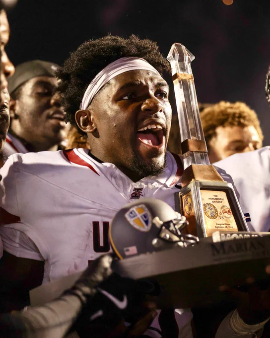 Fataki gets pumped while holding the trophy.