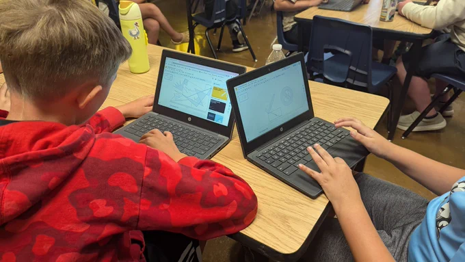 Student using shapes and lines to create digital artwork on Google Slides
