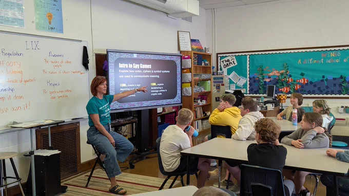 A teacher talking to a class about codes and ciphers 