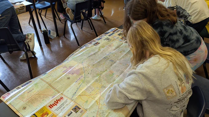 Students studying a map of Springfield 