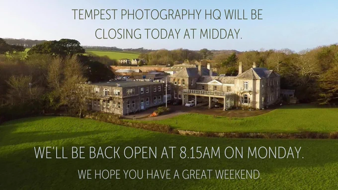 Aerial view of Tempest Photography headquarters, a large historic building surrounded by fields and trees. Overlaid text reads: “Tempest Photography HQ will be closing today at midday. We’ll be back open at 8.15am on Monday. We hope you have a great weekend.
