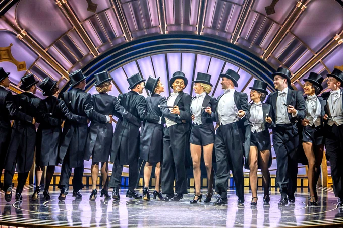 A photo showing a group of performers dressed in top hats and tails 