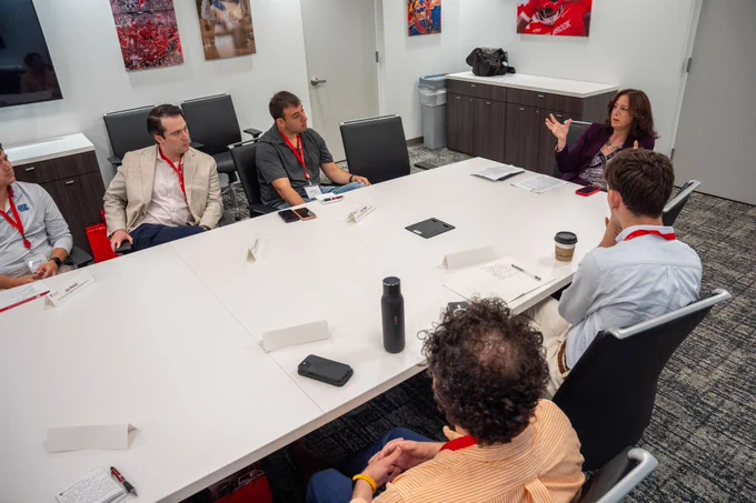 Me talking to a group of congress staff members while sitting at a conference table.