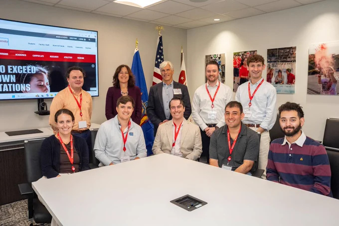 Kevin Gardner, me, and eight congress staff members posing for a photo in a conference room.