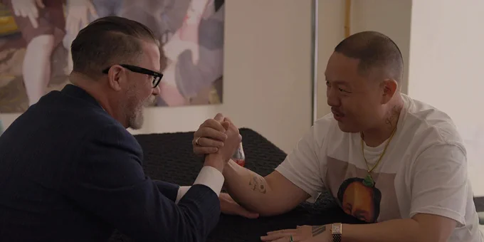 Fascist Proud Boys founder Gavin McInnes (left) arm wrestles director Eddie Huang (right) in a still from the documentary VICE IS BROKE. 