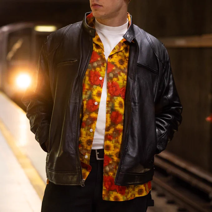 A close-up of a person wearing the Max Payne Low Resolution button up shirt over a white T-shirt and under a black leather jacket.