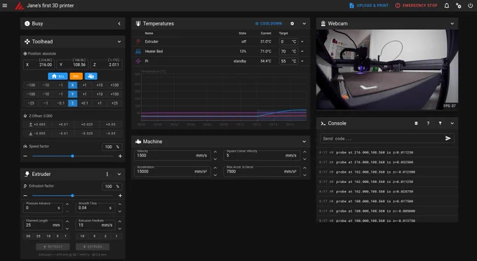 3D printer control interface for 'Jane's first 3D printer' showing a comprehensive dashboard with multiple panels. The interface displays printer status as 'Busy' with temperature monitoring for extruder (31.0°C, target 0°C), heated bed (71.0°C, target 70°C), and Raspberry Pi (54.4°C, target 55°C). A temperature graph shows cooling trends over time. The toolhead control panel shows absolute positioning coordinates (X: 216.00, Y: 108.56, Z: 2.011) with directional movement buttons. Machine settings display velocity at 1500 mm/s and acceleration at 15000 mm/s². The extruder panel shows 100% extrusion factor with pressure advance and smooth time controls. A webcam feed in the upper right shows the physical 3D printer with its print bed and extruder assembly. The console panel at bottom right displays recent probe commands with coordinate readouts. The interface includes upload & print, emergency stop, and various configuration options typical of web-based 3D printer management software.