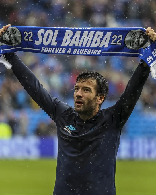 Brian Barry-Murphy holds aloft a Sol Bamba scarf.
