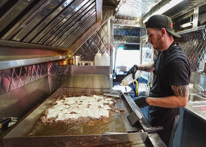 Chef makes cheesesteaks for Jesús Luzardo's Cheesesteaks for Charity event.