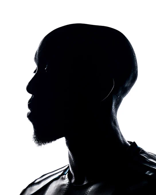 A silhouette of a player in a Newcastle United shirt. 