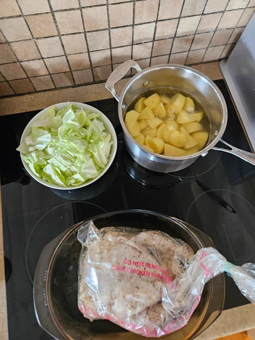 Ingredients top left of a bowl of cabbage pieces. Top right a pot of potato pieces in water. Bottom is a casserole with a chicken in a bag in it.