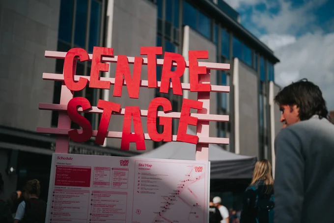 A man looking at Centre Stage event day signage