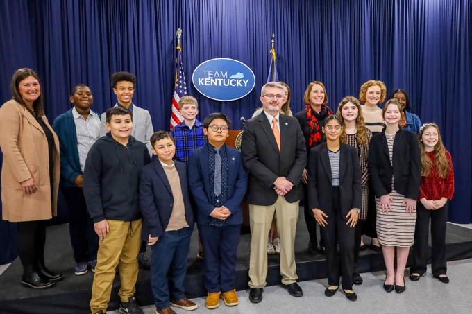 Commissioner of Education Robbie Fletcher (middle) poses with a group of Warren County Middle School 6th-grade gifted and talented students during the Gifted Education Month proclamation ceremony.