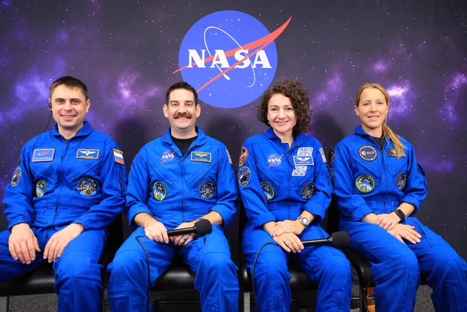 The four members of NASA's SpaceX Crew-12 mission \u2014 Roscosmos cosmonaut Andrey Fedyaev, NASA astronauts\u202FJack Hathaway and Jessica Meir, and ESA (European Space Agency) astronaut Sophie Adenot \u2014 sit in chairs, wearing blue flight suits. Behind them, a backdrop displays a dark nebula and the NASA \"meatball\" insignia. Credit: NASA/Kim Shiflett