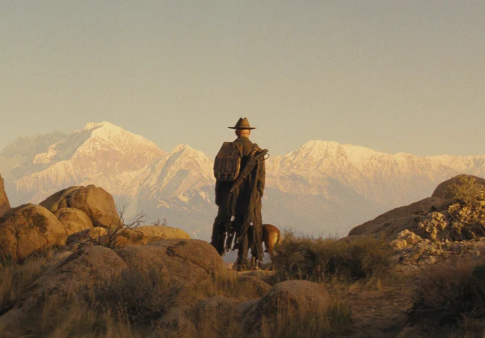 The Ghoul and CX404 look out at a mountainous landscape, beginning their journey to Colorado.