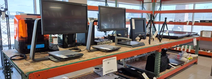Video magnifiers, tripods, and other AV equipment on the shelves at Surplus.