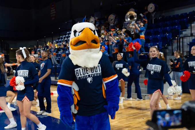 Swoop at blue out basketball game in blue out shirt.